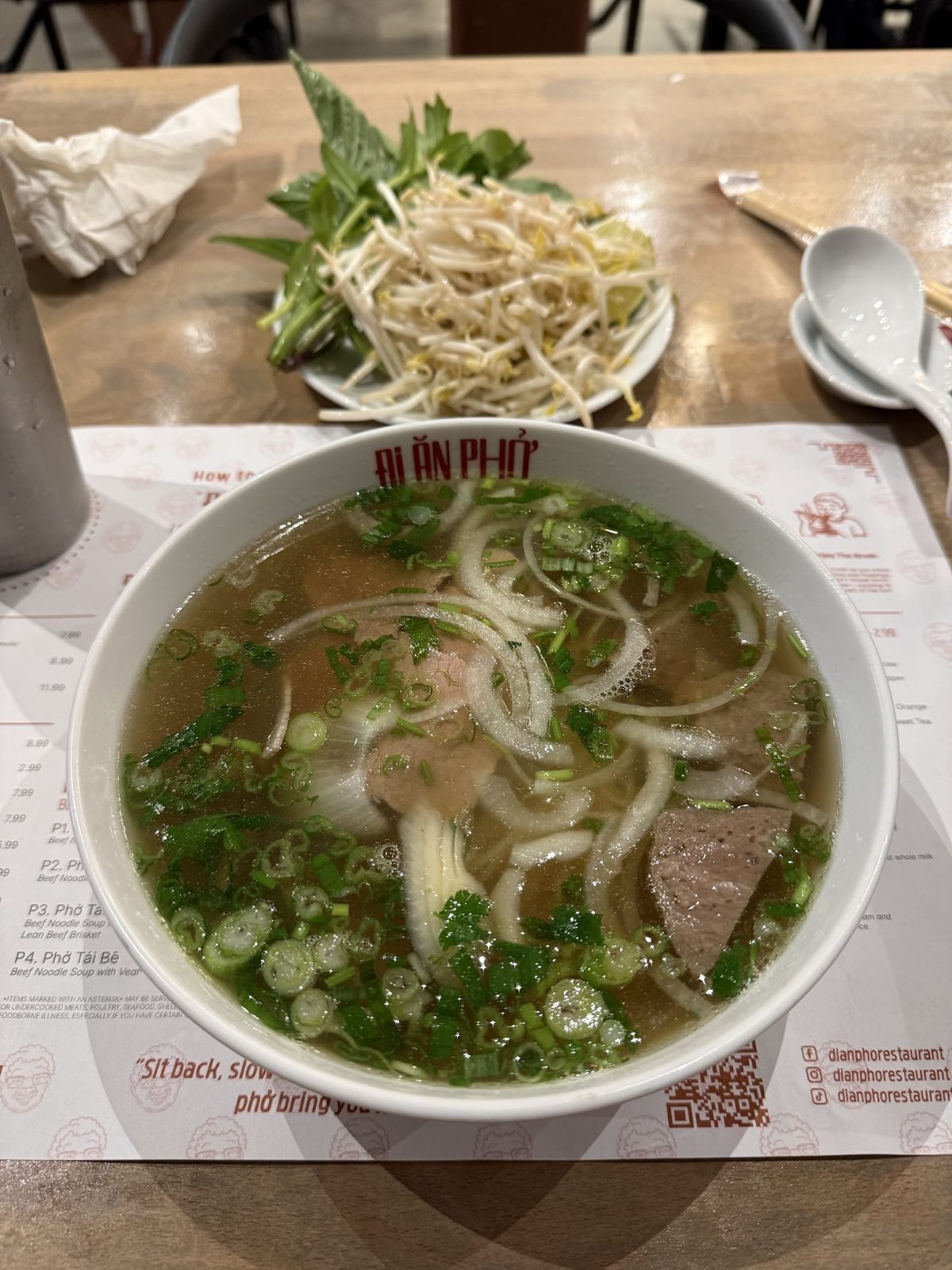Bowl of beef phở with herbs
